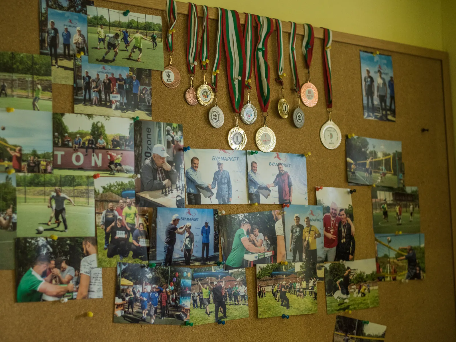A board of photographs and medals from the Group's sporting and corporate events.